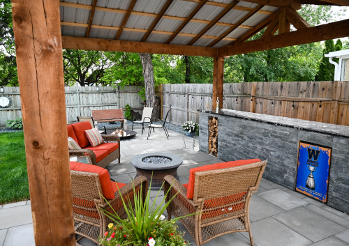 Chairs surrounding a fire table in a outdoor living space